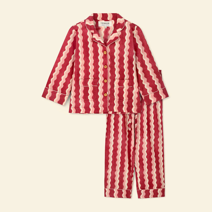 A two-piece Yonder pajama set featuring a red and cream wavy stripe pattern, laid flat on a light beige background. The set includes a long-sleeve button-up shirt with a collar and front pockets, and matching pants.