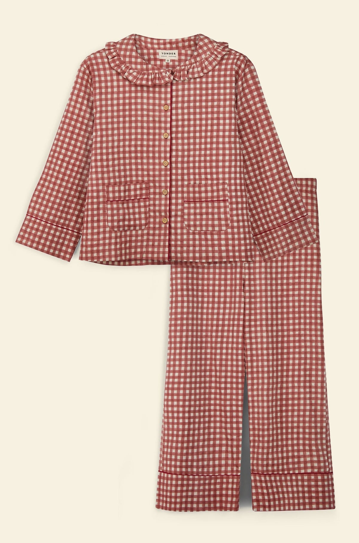 A two-piece women's pajama set featuring a red and white gingham checkered pattern, including a long-sleeve button-front top with a ruffled collar and matching wide-leg pants, laid flat against a light gray background.