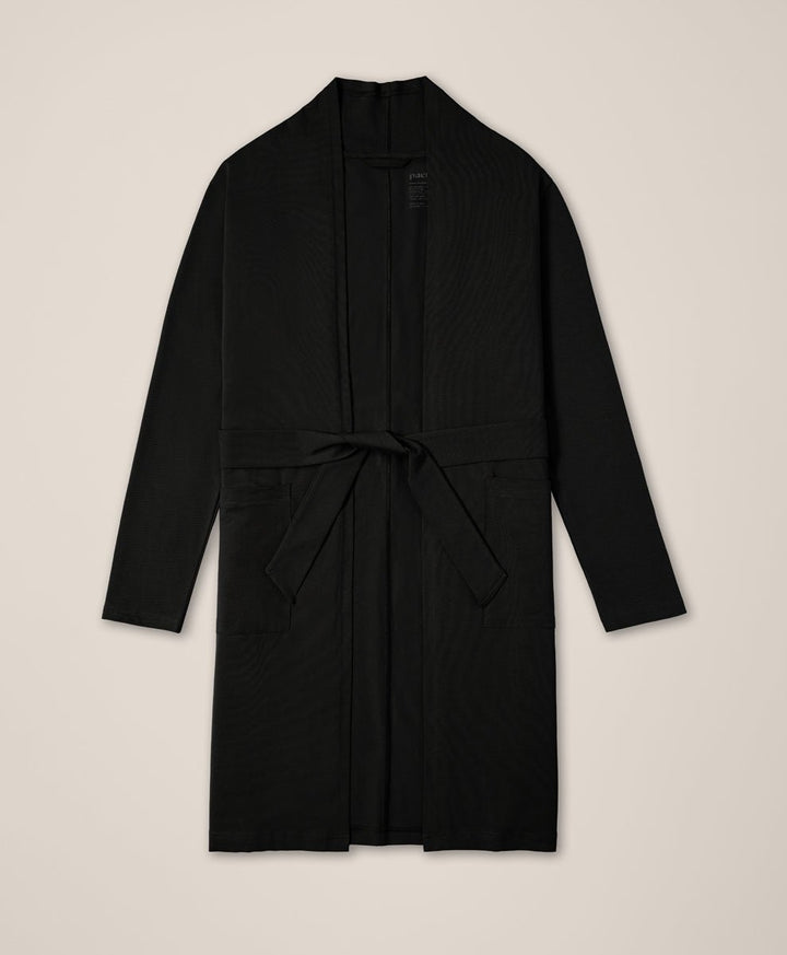 Black duster on a beige background
