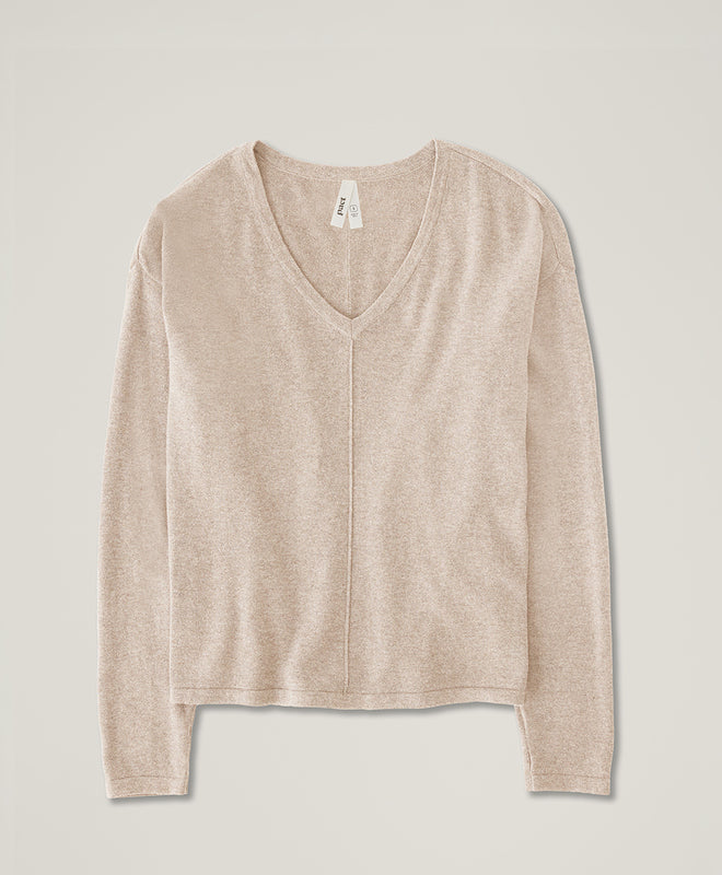 Beige long-sleeve shirt on a light gray background