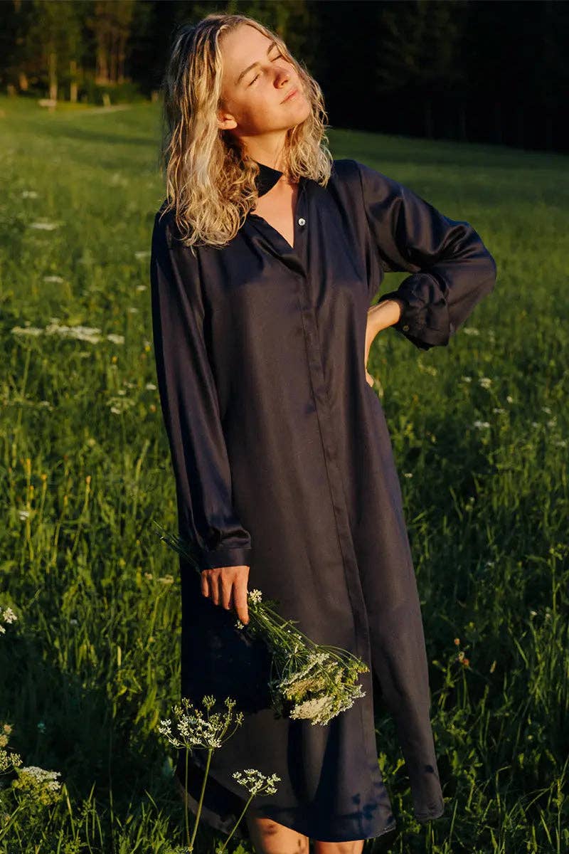 The Essential Shirt Dress - Black - on model outside in a grassy field with flowers - Echo Market