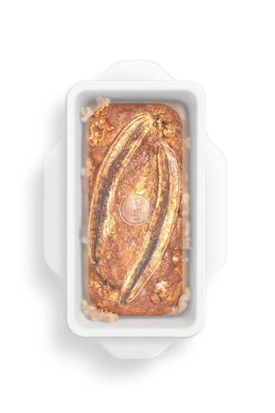 Silicone Stretch Loaf Baking Lids Set - Pictured covering a bread pan containing a fresh loaf - Echo Market