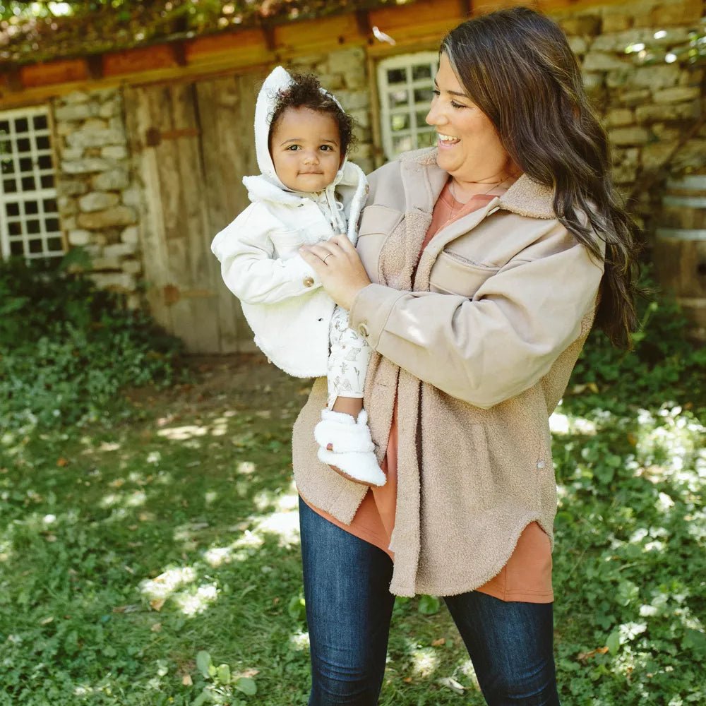 Sherpa Baby Stay-On Booties - Alabaster - Shown on baby model held by adult model outside - Echo Market